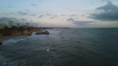 Aerial drone view of cliffs and beaches in Portimao during the sunset Stock Footage 167924612