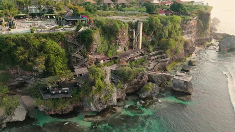 Aerial Drone View of Cliffside Resort and Rocky Coast Uluwatu Bali Видео 342830990