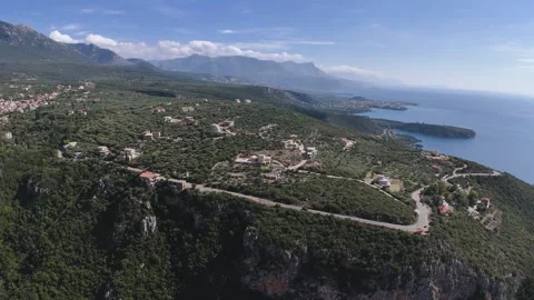 Aerial Drone View of Cliffside Road with Coastal Village and Mountains Stock-Footage 331083456