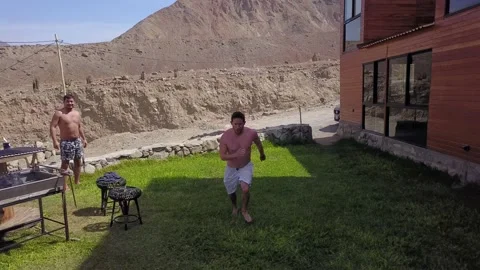 Aerial drone view closeup of a man jumping into the pool with friends at the swi 库存影片 199571493