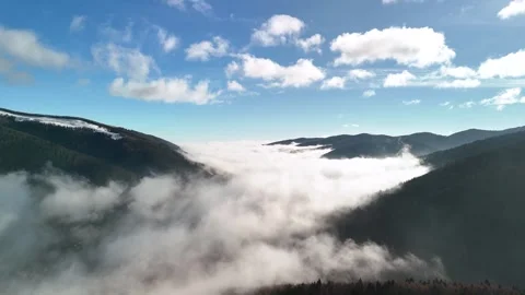 Aerial drone view of clouds covering a valley Stock Footage 296484597