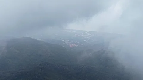 Aerial drone view of cloudy tropical forest and coastline Stockbeeldmateriaal 333043605