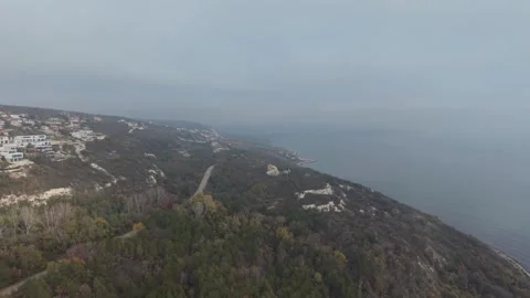 Aerial drone view of coastal cliffs and misty shoreline landscape Stock Footage 321389284