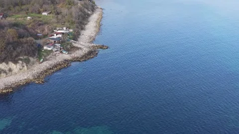 Aerial drone view of coastal cliffs, sandy beach and clear sea Stock Footage 322902096