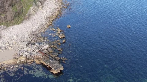 Aerial drone view of coastal cliffs, sandy beach and clear sea Stock Footage 322902106