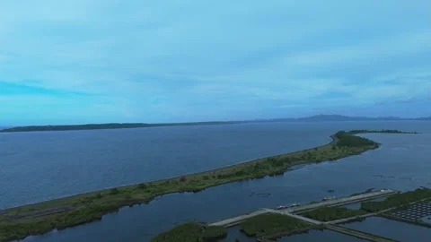Aerial drone view of coastal sand spit, mangrove wetlands and aquaculture. Stock Footage 337372753