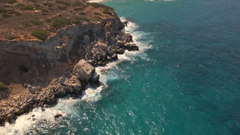 Aerial drone view of the coastline with cliffs and the sea with waves in Crete, Stock Footage 260382745