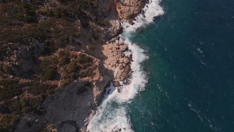 Aerial drone view of the coastline with cliffs and the sea with waves in Crete, Stock Footage 260417998