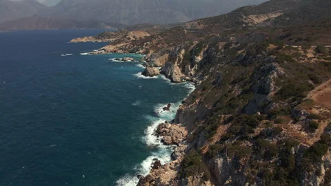 Aerial drone view of the coastline with cliffs and the sea with waves in Crete, Stock Footage 260418593