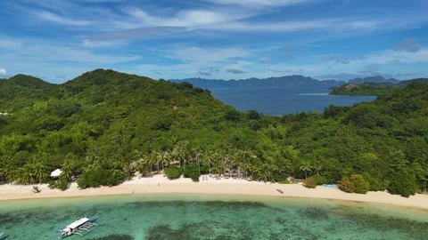 Aerial drone view of Coco Beach, with its golden sands and crystal-clear waters. Stock Footage 295913617