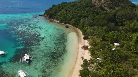 Aerial drone view of Coco Beach, with its golden sands and crystal-clear waters. Stock Footage 295913809