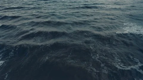 An aerial drone view of cold ocean waves in the evening Stock Footage 145649845