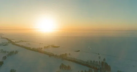 Aerial drone view of cold winter landscape with arctic field, trees covered with Stock Footage 129241401