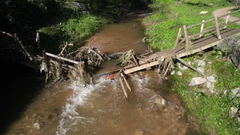 Aerial drone view of a collapsed pedestrian bridge in Ribeira das Vinhas, PT Stock Footage 226224007
