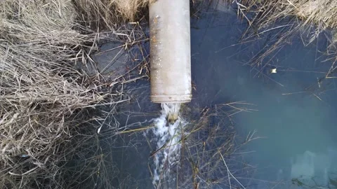 Aerial drone view, concrete pipe transporting the polluted sewage water Stock Footage 149205124