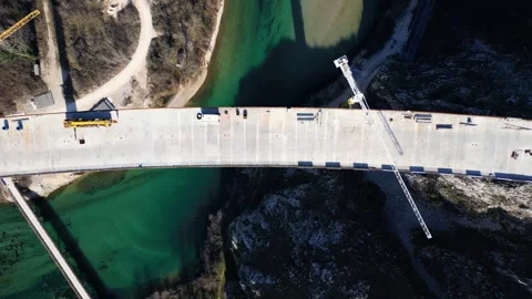 Aerial drone view of the construction of a high concrete bridge over the river Stock Footage 265226643