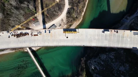 Aerial drone view of the construction of a high concrete bridge over the river Stock Footage 267694071