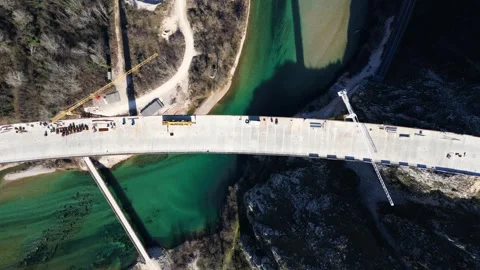 Aerial drone view of the construction of a high concrete bridge over the river Stock Footage 271360922