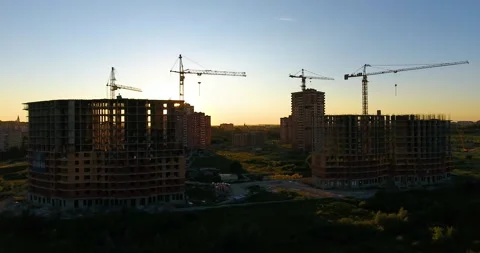 Aerial drone view of construction of a new residential complex at sunset 스톡 동영상 169408995