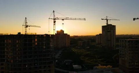 Aerial drone view of construction of a new residential complex at sunset 스톡 동영상 169409945