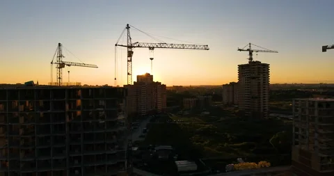 Aerial drone view of construction of a new residential complex at sunset 스톡 동영상 169410259
