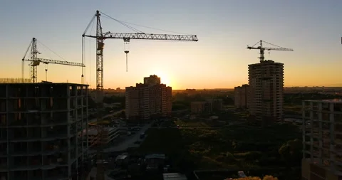 Aerial drone view of construction of a new residential complex at sunset 스톡 동영상 169410858