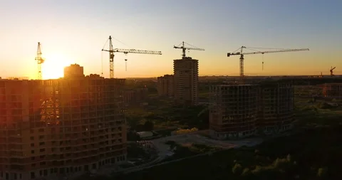 Aerial drone view of construction of a new residential complex at sunset 스톡 동영상 169411529
