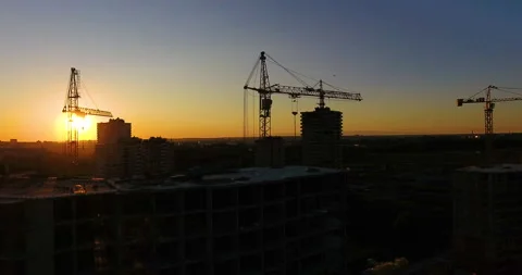 Aerial drone view of construction of a new residential complex at sunset 스톡 동영상 169411899