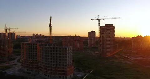 Aerial drone view of construction of a new residential complex at sunset 스톡 동영상 169414257