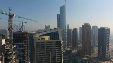 Aerial drone view of construction skyscraper buildings and crane in Dubai Stock Footage 100864579