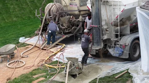 Aerial drone view of construction workers finishing gunite concrete pool with Stock Footage 333398788