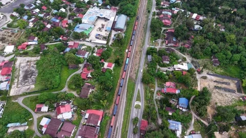 Aerial drone view of container train moving through Bukit Mertajam Stock Footage 337987429