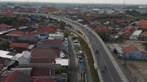 Aerial Drone View of Curved Flyover Bridge and Urban Traffic in Sidoarjo Indones Stock Footage 316488624