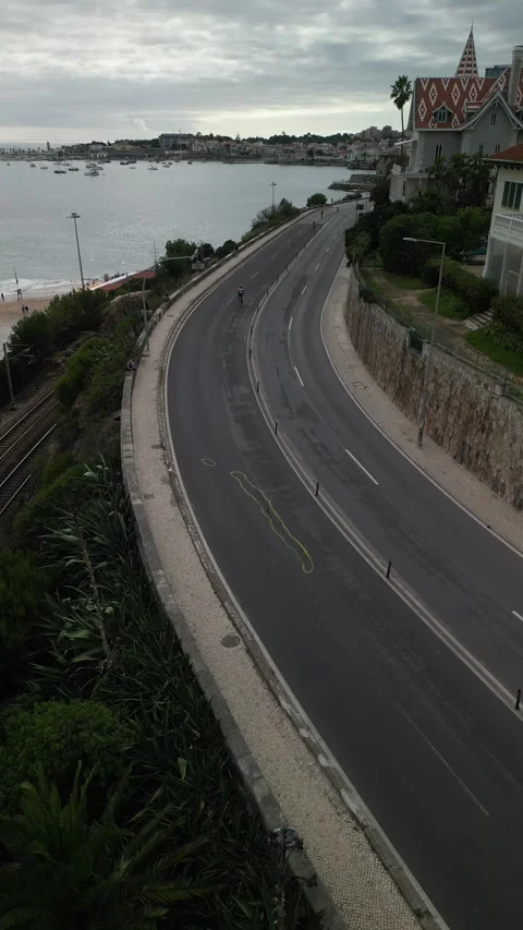Aerial drone view of cyclists in the Ironman event in Cascais, Portugal Stock Footage 288868100