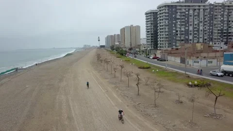 Aerial drone view of cyclists riding in San Miguel, Lima, Peru Stock Footage 142148804