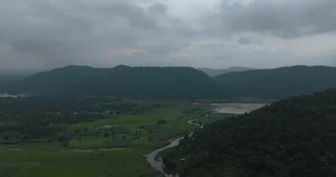 Aerial drone view of dark monsoon evening sky over Chandubi lake valley Stock Footage 344110730
