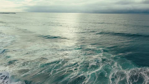Aerial drone view of dark ocean waves reflecting sunlight near Pacific Beach Video stock 339252443