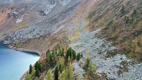 Aerial Drone View of a Deep Blue Alpine Lake and Rocky Autumn Shoreline Stock Footage 347897237