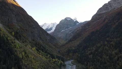 Aerial drone view of a deep mountain gorge with a winding river Stock Footage 337529072