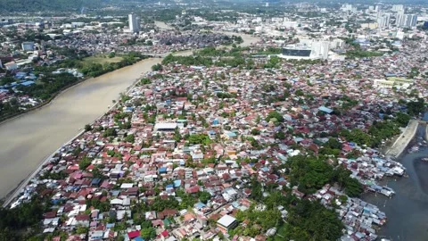 Aerial drone view of dense urban neighborhood and bridge in Davao Philippine Stock Footage 337513306
