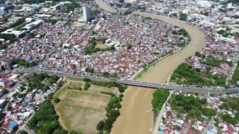 Aerial drone view of dense urban neighborhood and bridge in Davao Philippine Video stock 337513451