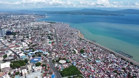 Aerial drone view of dense urban neighborhood and bridge in Davao Philippine Stock Footage 337513497