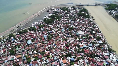 Aerial drone view of dense urban neighborhood and bridge in Davao Philippine Stock Footage 337513629