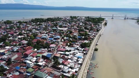 Aerial drone view of dense urban neighborhood and bridge in Davao Philippine Stock Footage 337513641
