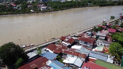 Aerial drone view of dense urban neighborhood and bridge in Davao Philippine Stock Footage 337513685