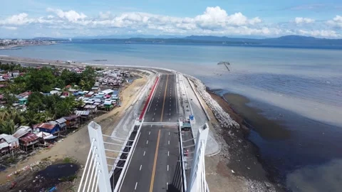 Aerial drone view of dense urban neighborhood and bridge in Davao Philippine Stock Footage 337513878