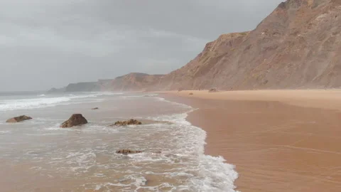 Aerial drone view of the deserted empty rocky beach and cliffs in Portugal. Stock Footage 140537035