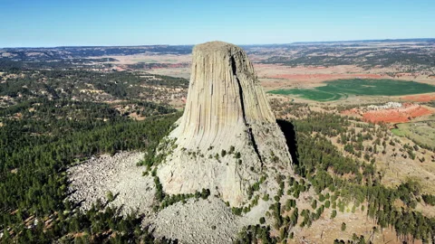 Aerial drone view of Devils Tower National Monument rising dramatically above Stock-Footage 330801533