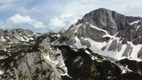 Aerial drone view of different mountain peaks in the spring still with snow Stock Footage 199484614