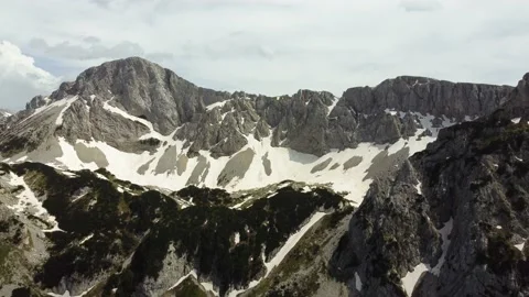 Aerial drone view of different mountain peaks in the spring still with snow. Stock Footage 220519792